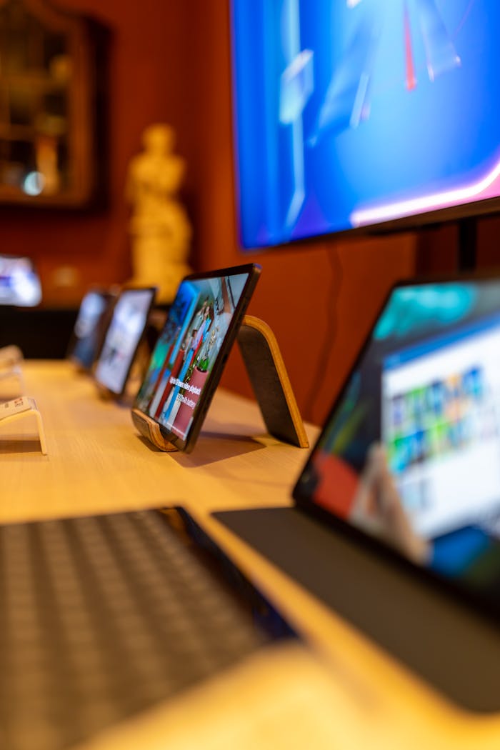 Close-up of tablets and keyboard in a high-tech showroom, showcasing modern technology.